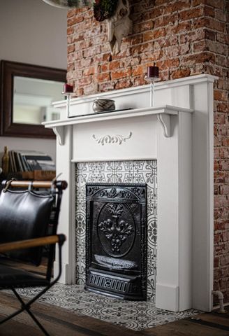 a living room with a fireplace and a fireplace