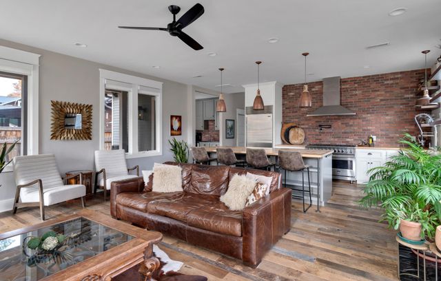 a living room with furniture kitchen view and a fireplace