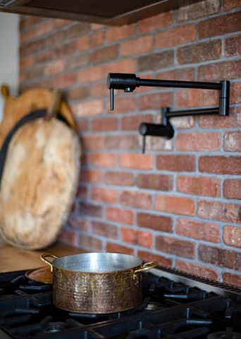 a kitchen with stainless steel appliances granite countertop a stove and a sink