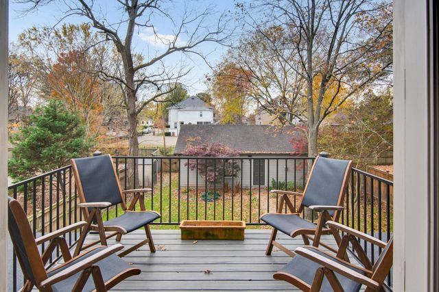a bathroom with a granite countertop sink two mirror and shower