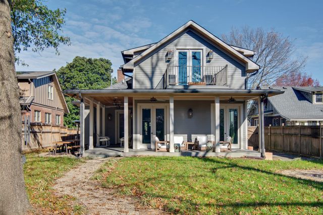 a view of a patio with a table chairs and a backyard