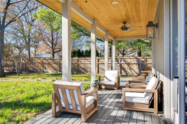 a view of a chair and table in backyard of the house