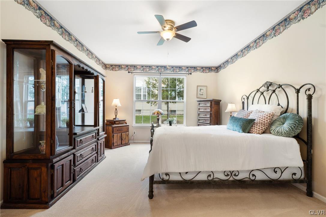 1882 Gregory Place Hellertown, PA 18055 - Photo 14 of 28 a bedroom with a large bed and a chandelier fan