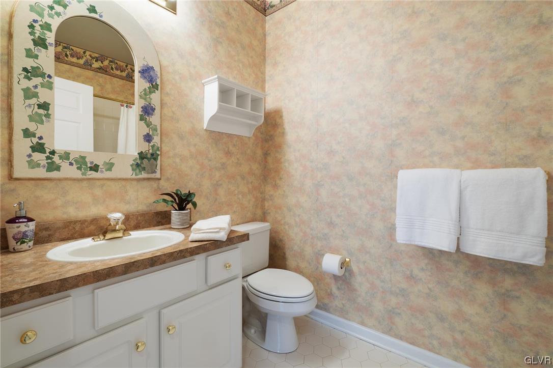 1882 Gregory Place Hellertown, PA 18055 - Photo 19 of 28 a bathroom with a granite countertop sink a toilet and a mirror