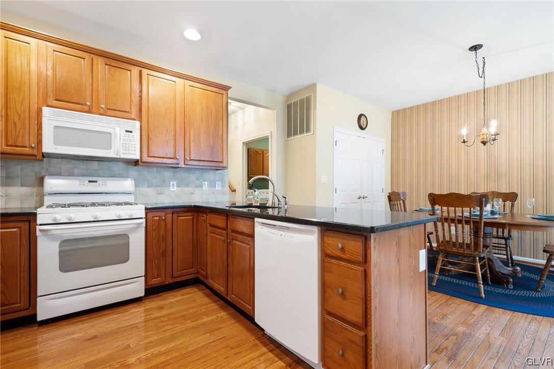 1882 Gregory Place Hellertown, PA 18055 - Photo 7 of 28 a kitchen with stainless steel appliances granite countertop a stove a sink and a microwave