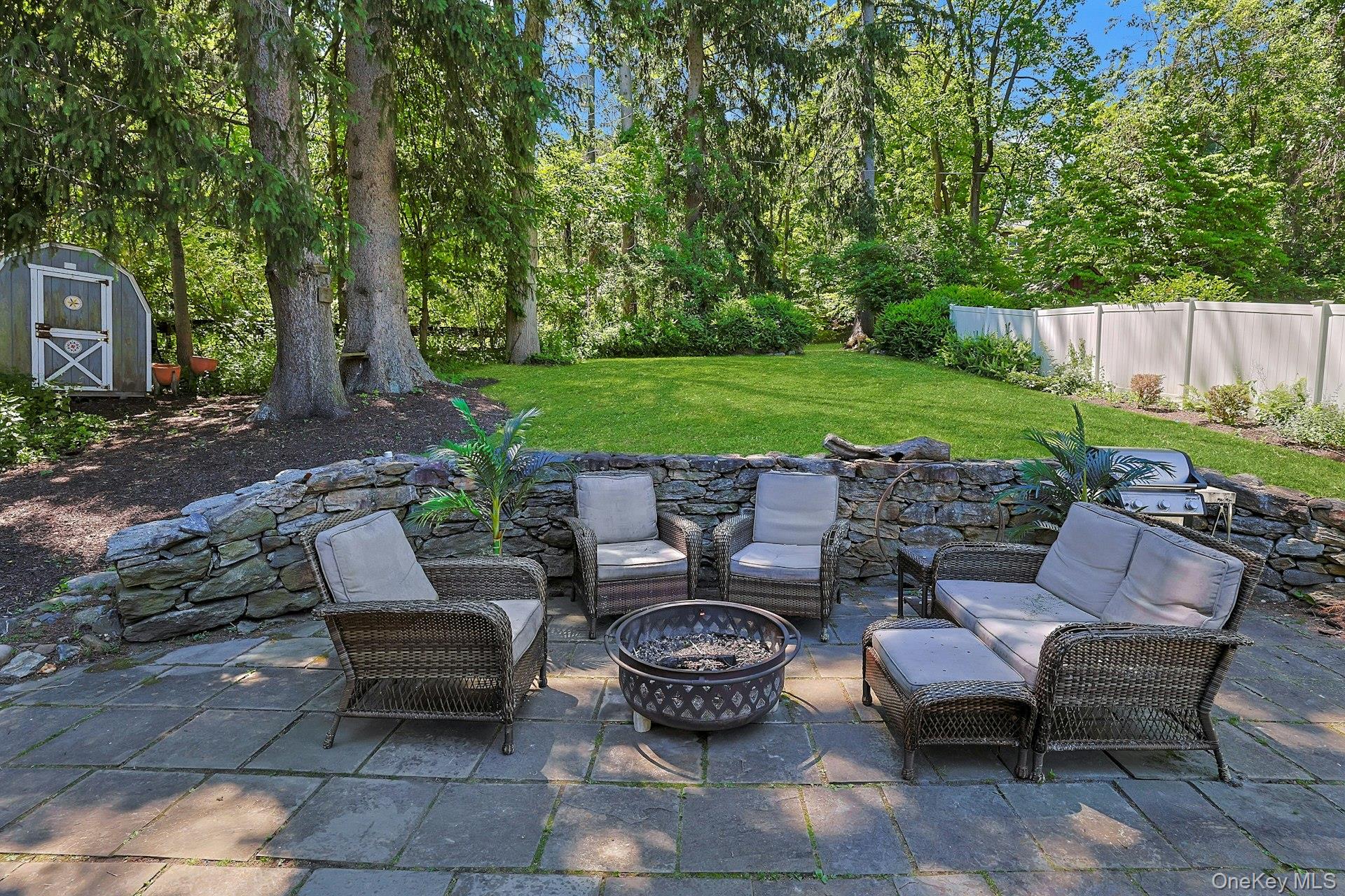 65 Douglas Road Chappaqua, NY 10514 - Photo 32 of 41 Surrounded by greenery and natural beauty, the backyard offers a quiet escape for outdoor entertaining.