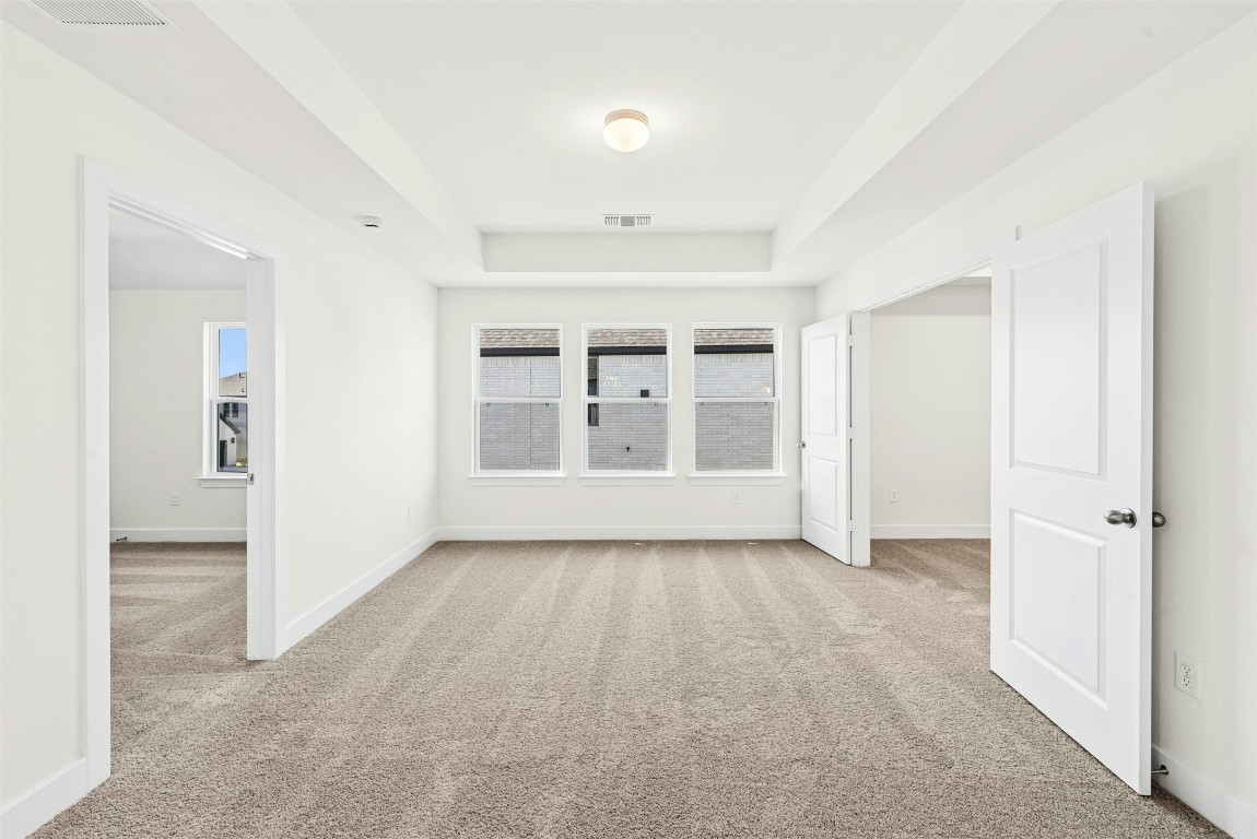 1520 Rodeo Ridge Drive Georgetown, TX 78628 - Photo 15 of 29 Unfurnished room featuring light carpet and a raised ceiling