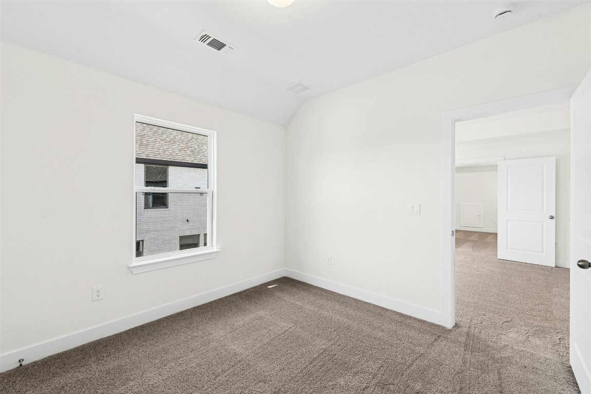 1520 Rodeo Ridge Drive Georgetown, TX 78628 - Photo 18 of 29 Unfurnished room featuring carpet and lofted ceiling