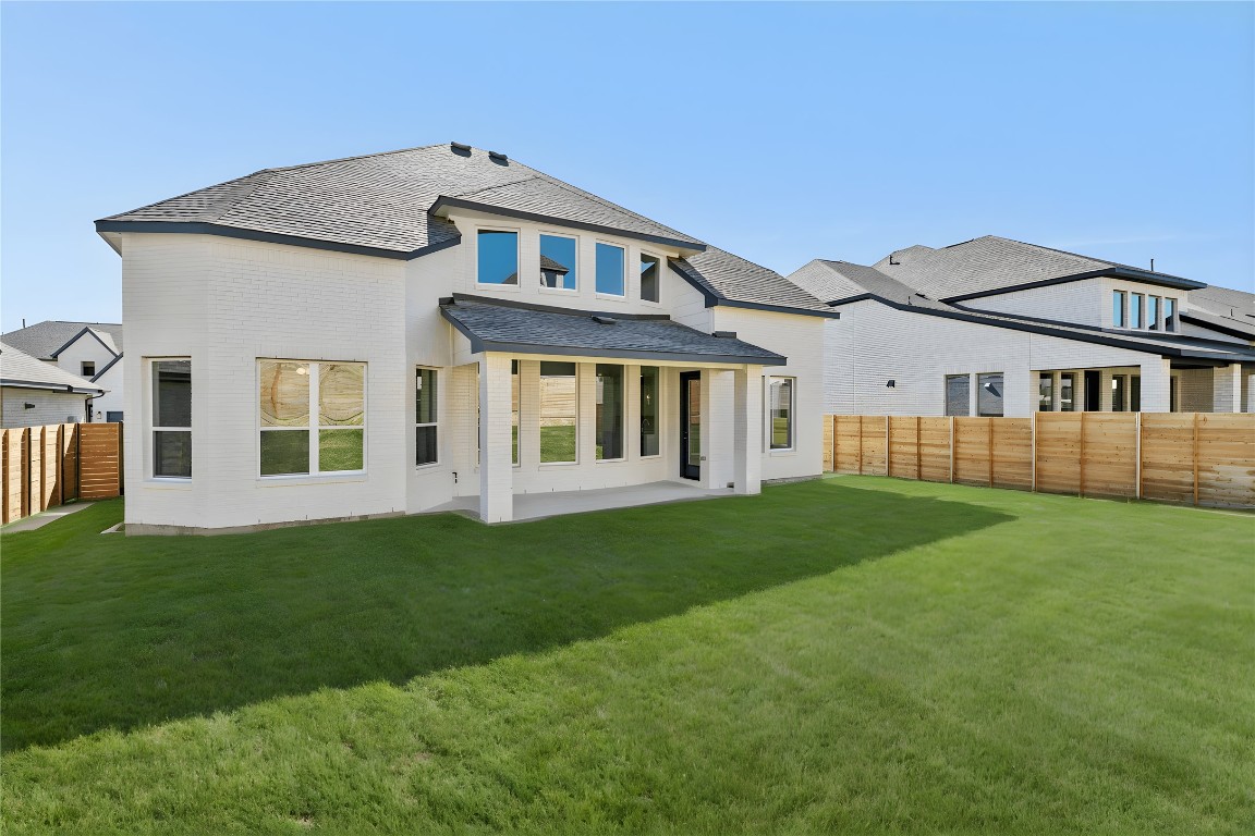 1520 Rodeo Ridge Drive Georgetown, TX 78628 - Photo 23 of 29 Back of property featuring a patio area, a fenced backyard, brick siding, and a shingled roof