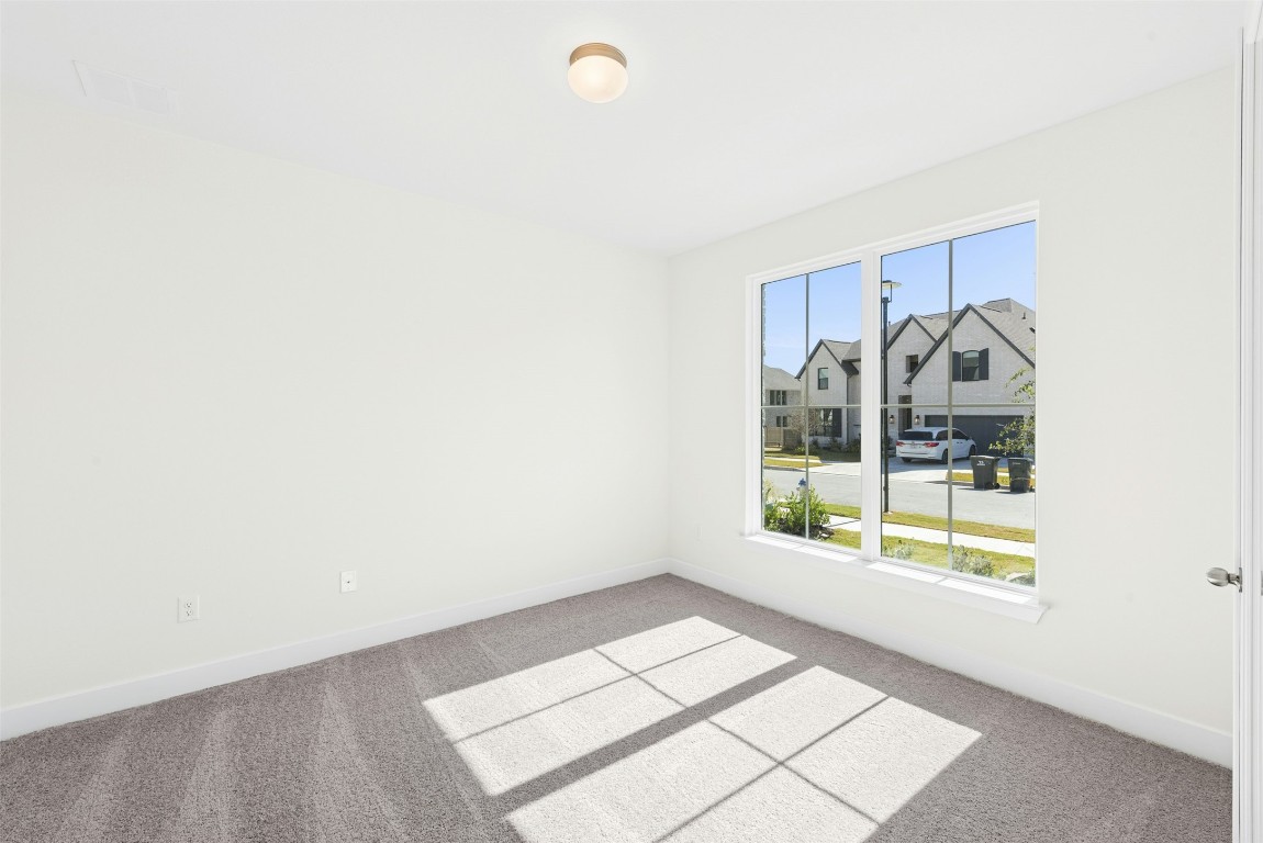 1520 Rodeo Ridge Drive Georgetown, TX 78628 - Photo 6 of 29 Unfurnished room featuring carpet floors and a residential view