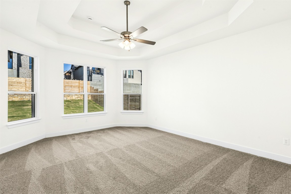 1520 Rodeo Ridge Drive Georgetown, TX 78628 - Photo 8 of 29 Carpeted empty room with a raised ceiling and a ceiling fan