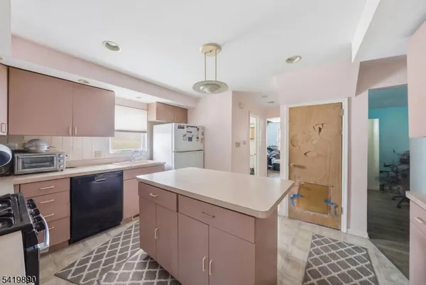 a kitchen with a sink stove and refrigerator