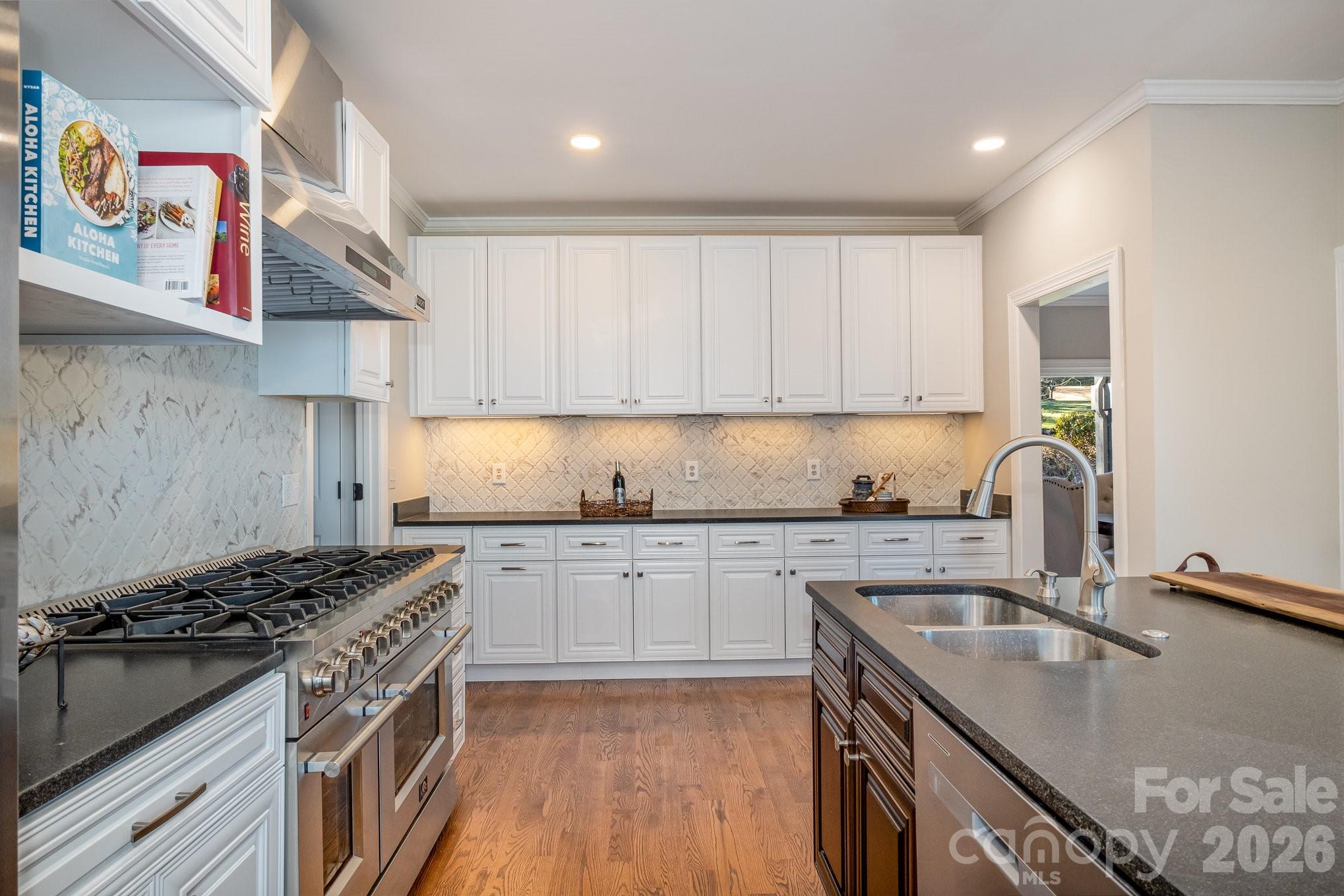 20105 Chapel Point Lane Cornelius, NC 28031 - Photo 20 of 39 a kitchen with stainless steel appliances granite countertop a sink stove and cabinets