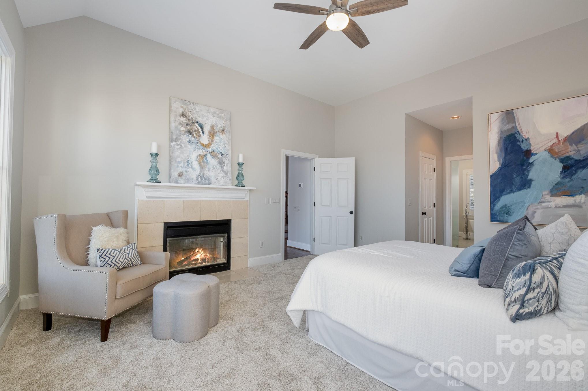 20105 Chapel Point Lane Cornelius, NC 28031 - Photo 25 of 39 a bedroom with a bed and a fireplace