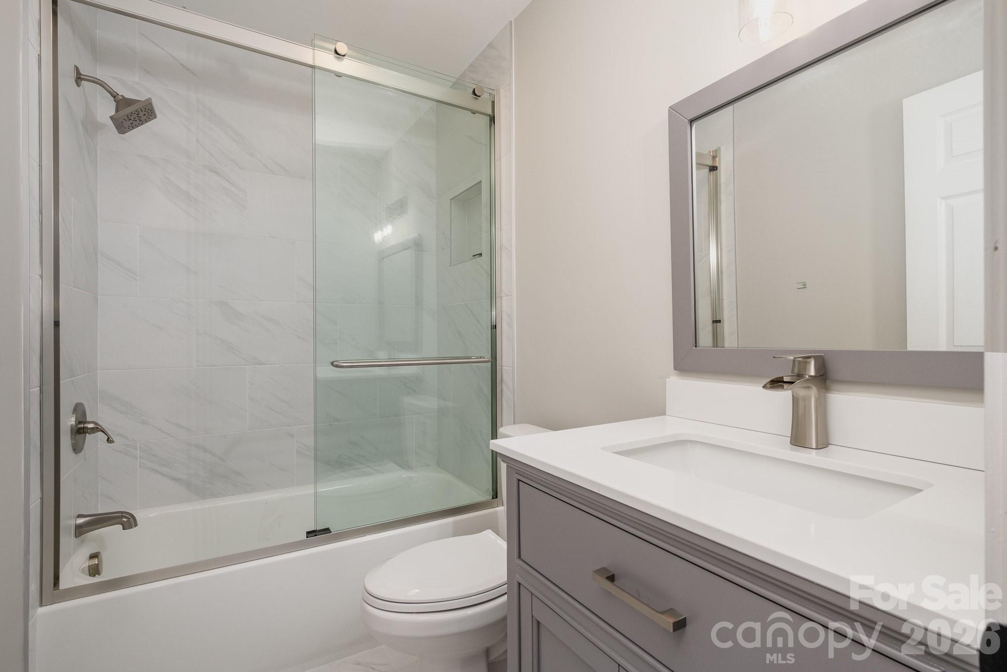 20105 Chapel Point Lane Cornelius, NC 28031 - Photo 28 of 39 a bathroom with a sink a toilet and shower
