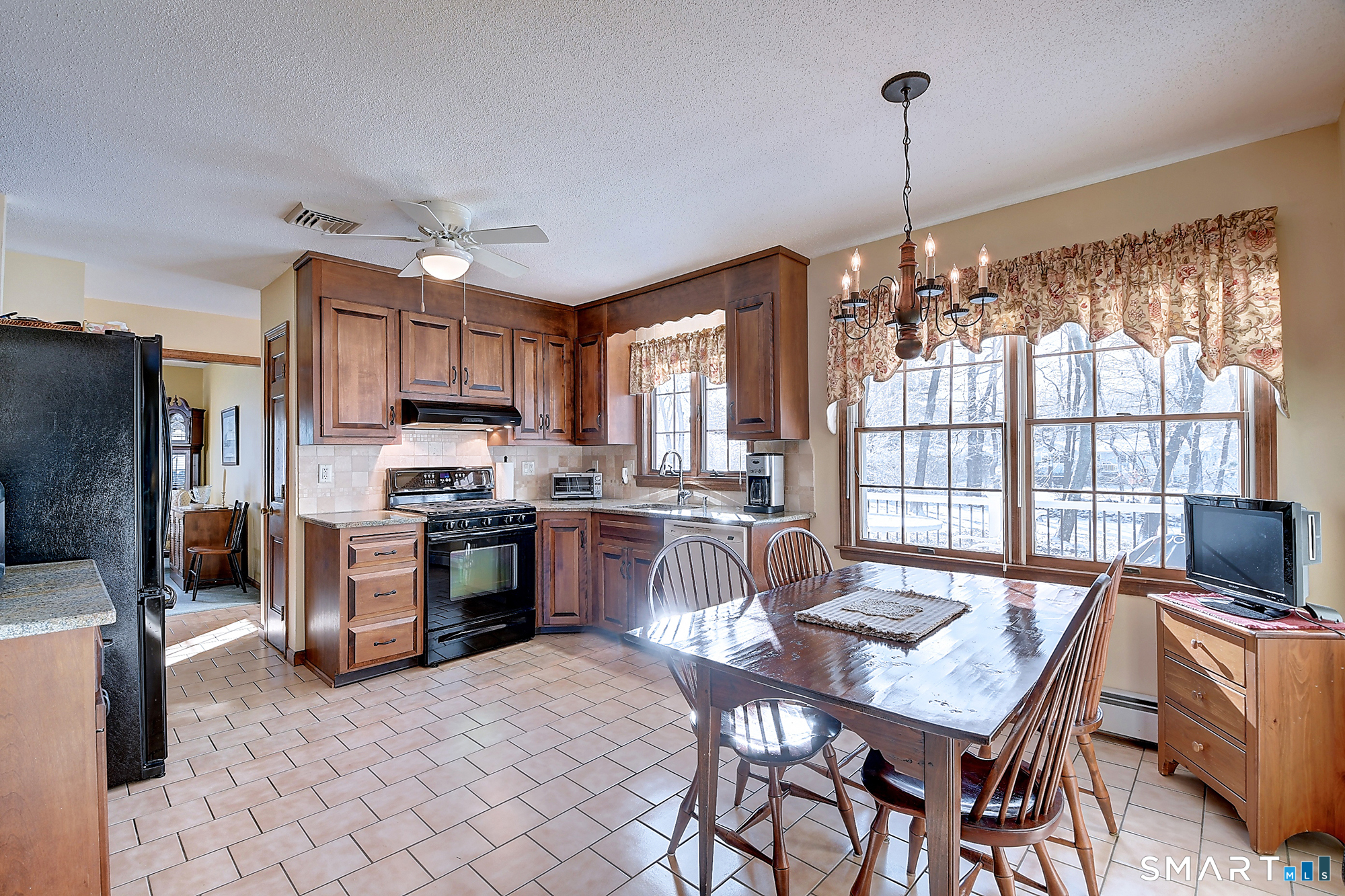 48 Devonshire Drive South Windsor, CT 06074 - Photo 12 of 35 a kitchen with stainless steel appliances granite countertop a stove top oven a sink a dining table and chairs