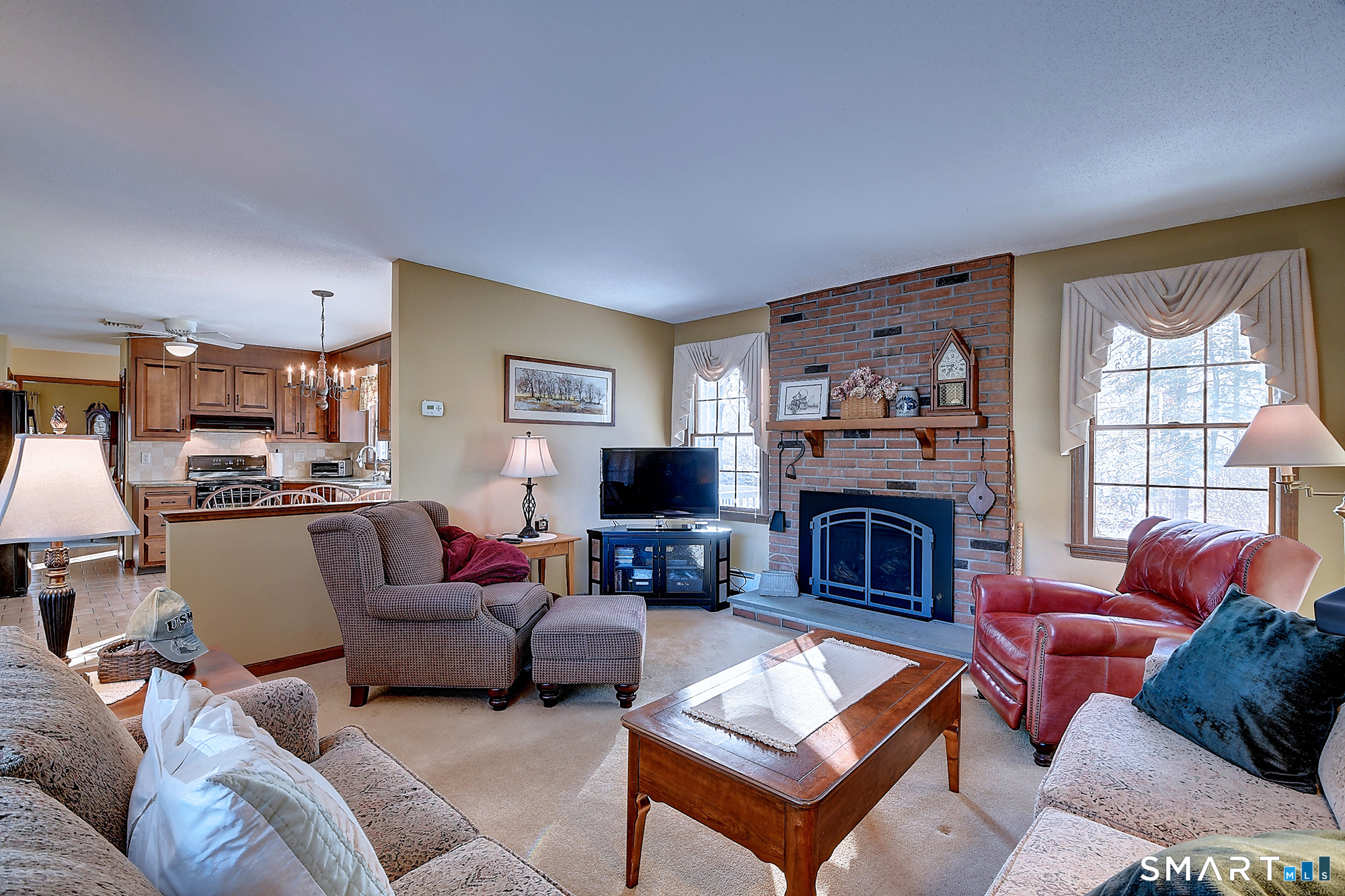 48 Devonshire Drive South Windsor, CT 06074 - Photo 15 of 35 a living room with furniture a fireplace and a flat screen tv