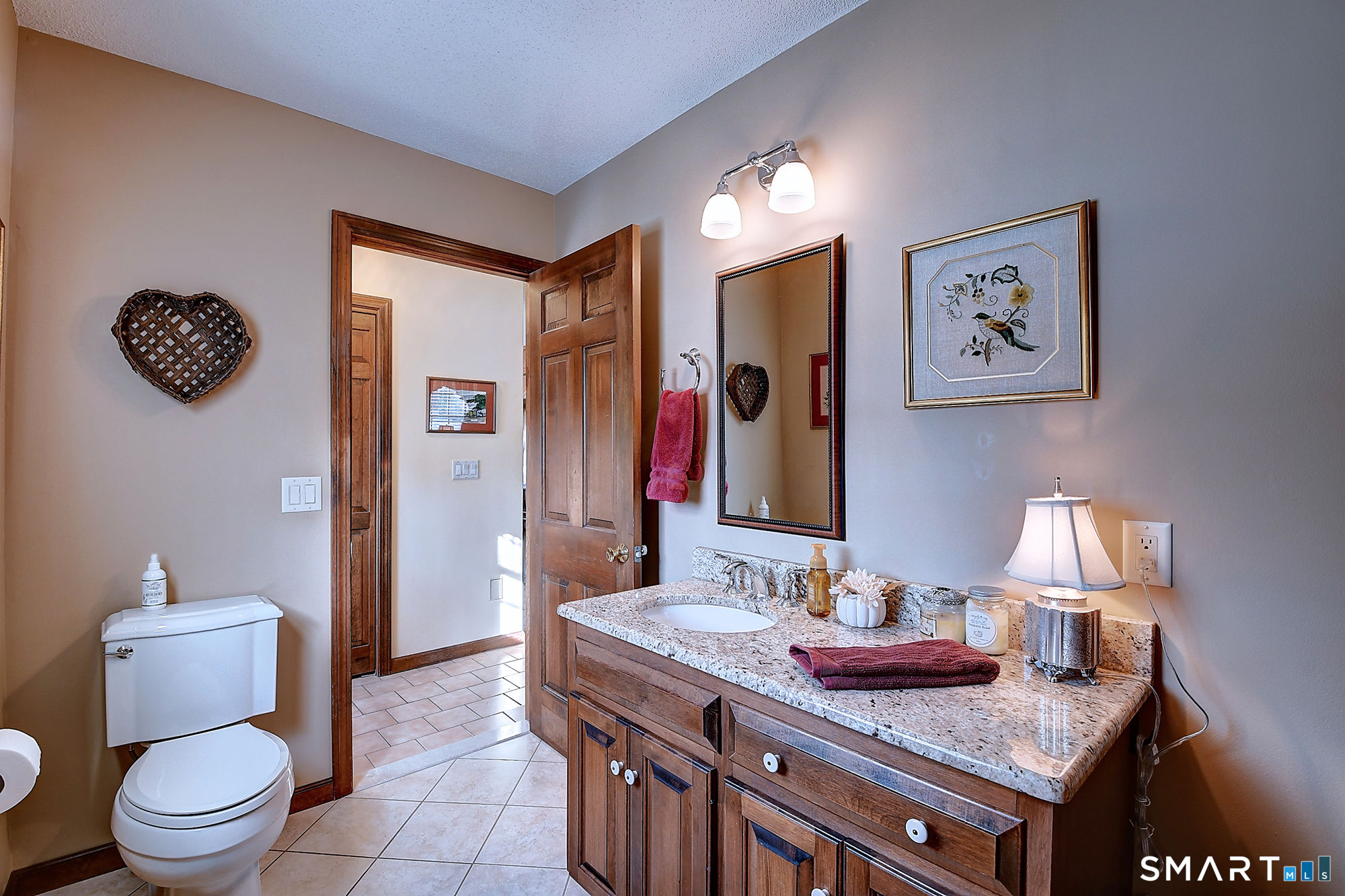 48 Devonshire Drive South Windsor, CT 06074 - Photo 18 of 35 a bathroom with a granite countertop sink and a mirror