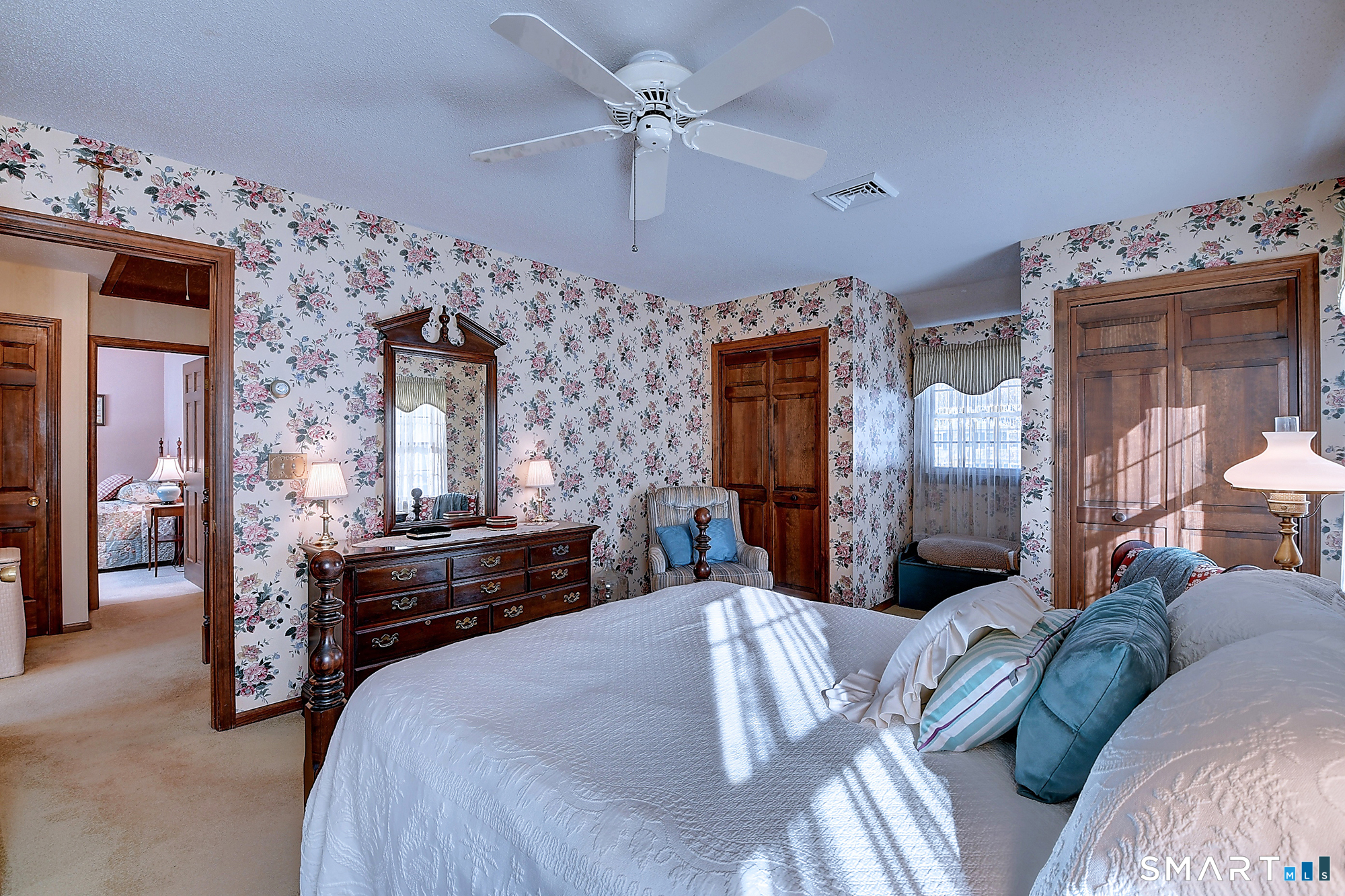 48 Devonshire Drive South Windsor, CT 06074 - Photo 25 of 35 a bedroom with a bed a chandelier and dresser