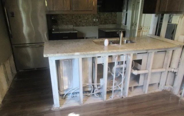 a view of kitchen with granite countertop window