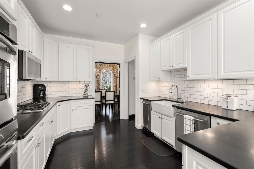 20 Rons Way Framingham, MA 01701 - Photo 15 of 41 a kitchen with granite countertop a stove top oven a sink a counter space and cabinets