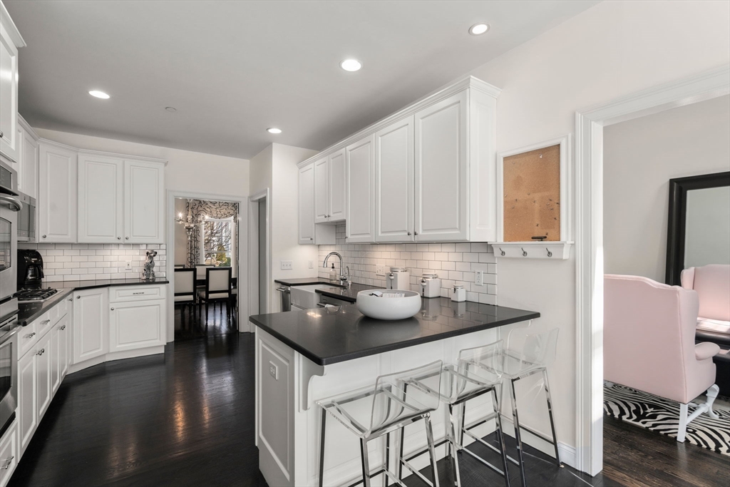 20 Rons Way Framingham, MA 01701 - Photo 16 of 41 a kitchen with a sink a stove and chairs
