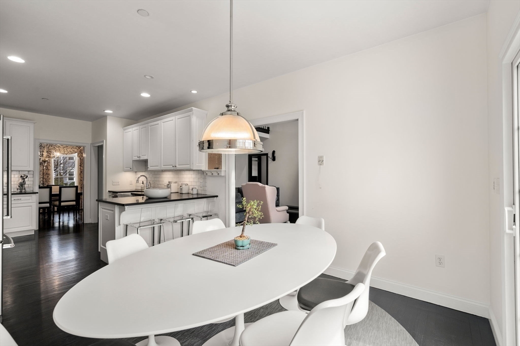 20 Rons Way Framingham, MA 01701 - Photo 19 of 41 a kitchen with stainless steel appliances a dining table chairs and white cabinets