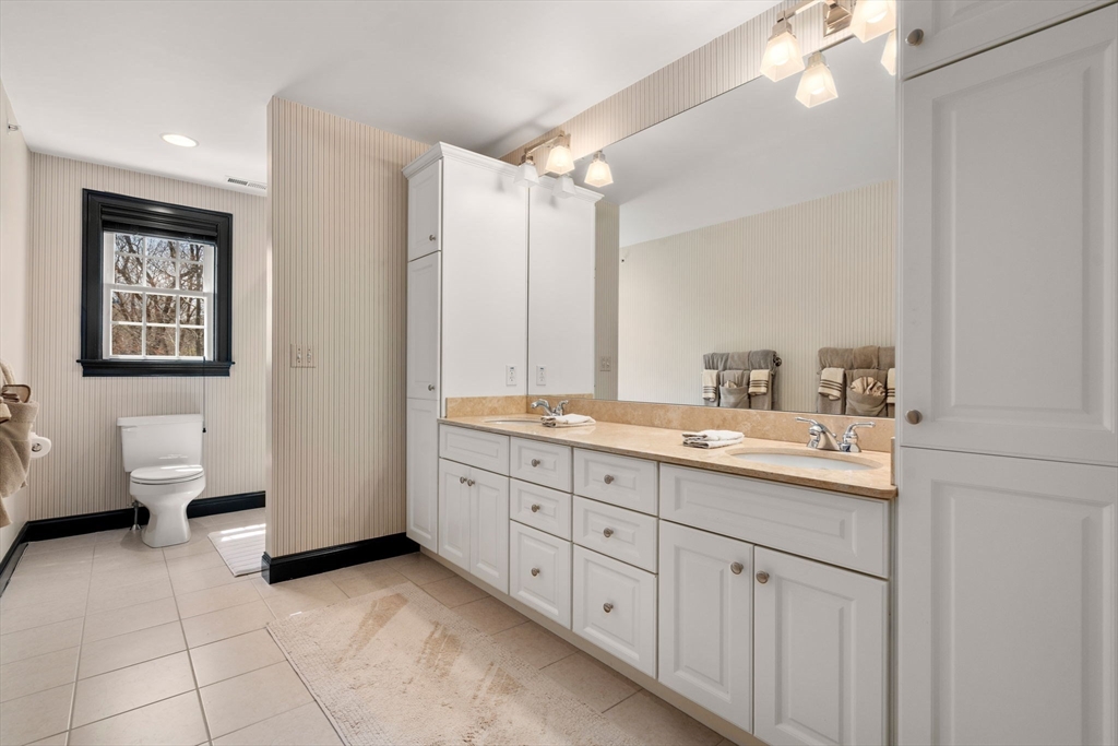 20 Rons Way Framingham, MA 01701 - Photo 30 of 41 a bathroom with a double vanity sink toilet and a mirror