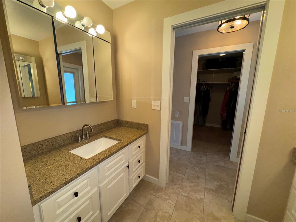 1893 North Lake Reedy Boulevard Frostproof, FL 33843 - Photo 20 of 56 a bathroom with a granite countertop sink a mirror and a