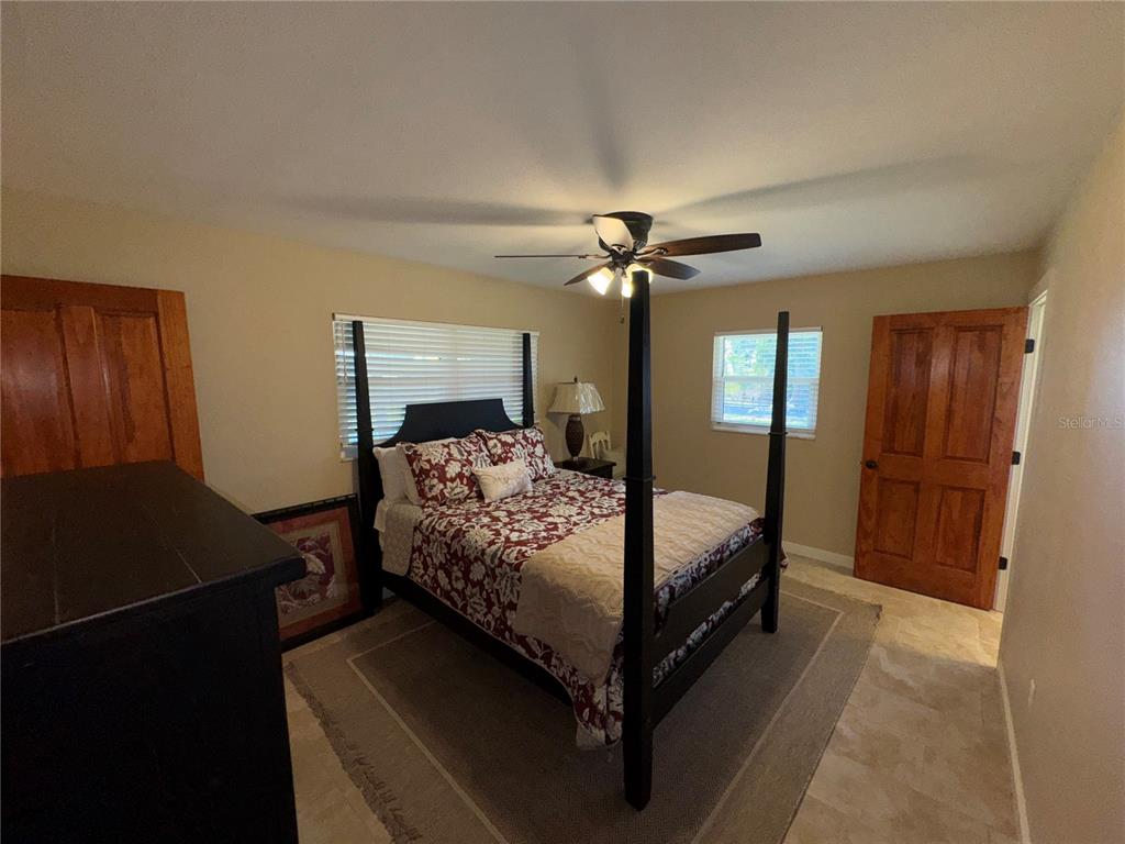 1893 North Lake Reedy Boulevard Frostproof, FL 33843 - Photo 24 of 56 a bedroom with a bed and a chandelier