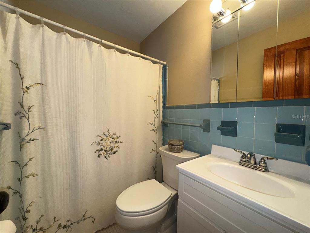 1893 North Lake Reedy Boulevard Frostproof, FL 33843 - Photo 25 of 56 a bathroom with a toilet a sink and a mirror