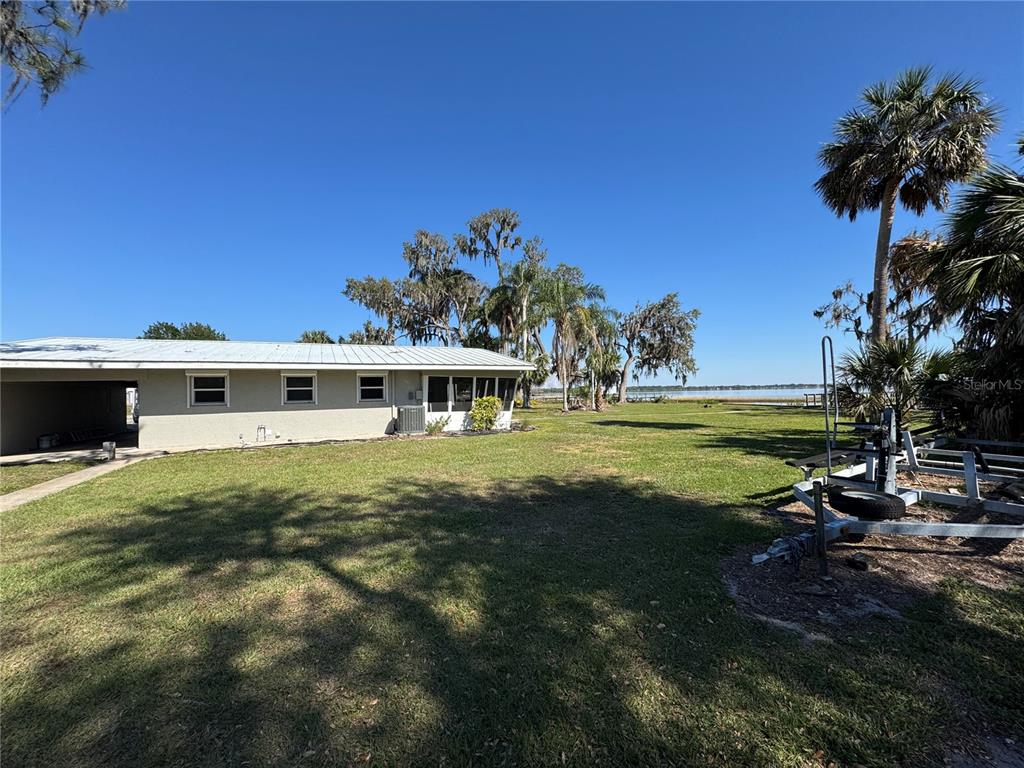 1893 North Lake Reedy Boulevard Frostproof, FL 33843 - Photo 31 of 56 a front view of a house with a yard