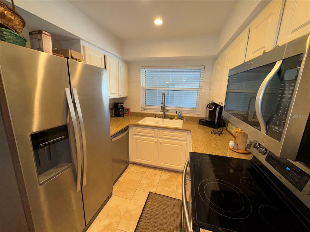 1893 North Lake Reedy Boulevard Frostproof, FL 33843 - Photo 6 of 56 a kitchen with stainless steel appliances a refrigerator stove and sink