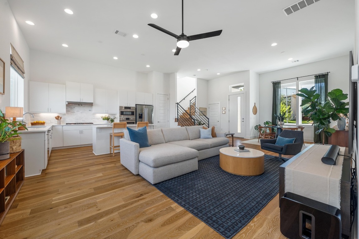 5428 Agatha Circle Austin, TX 78724 - Photo 38 of 40 a living room with furniture kitchen view and a wooden floor