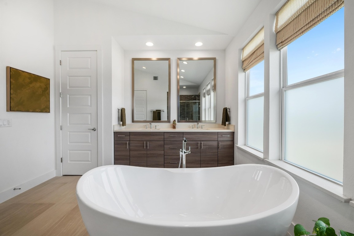 5428 Agatha Circle Austin, TX 78724 - Photo 20 of 40 a spacious bathroom with a tub a mirror and a shower