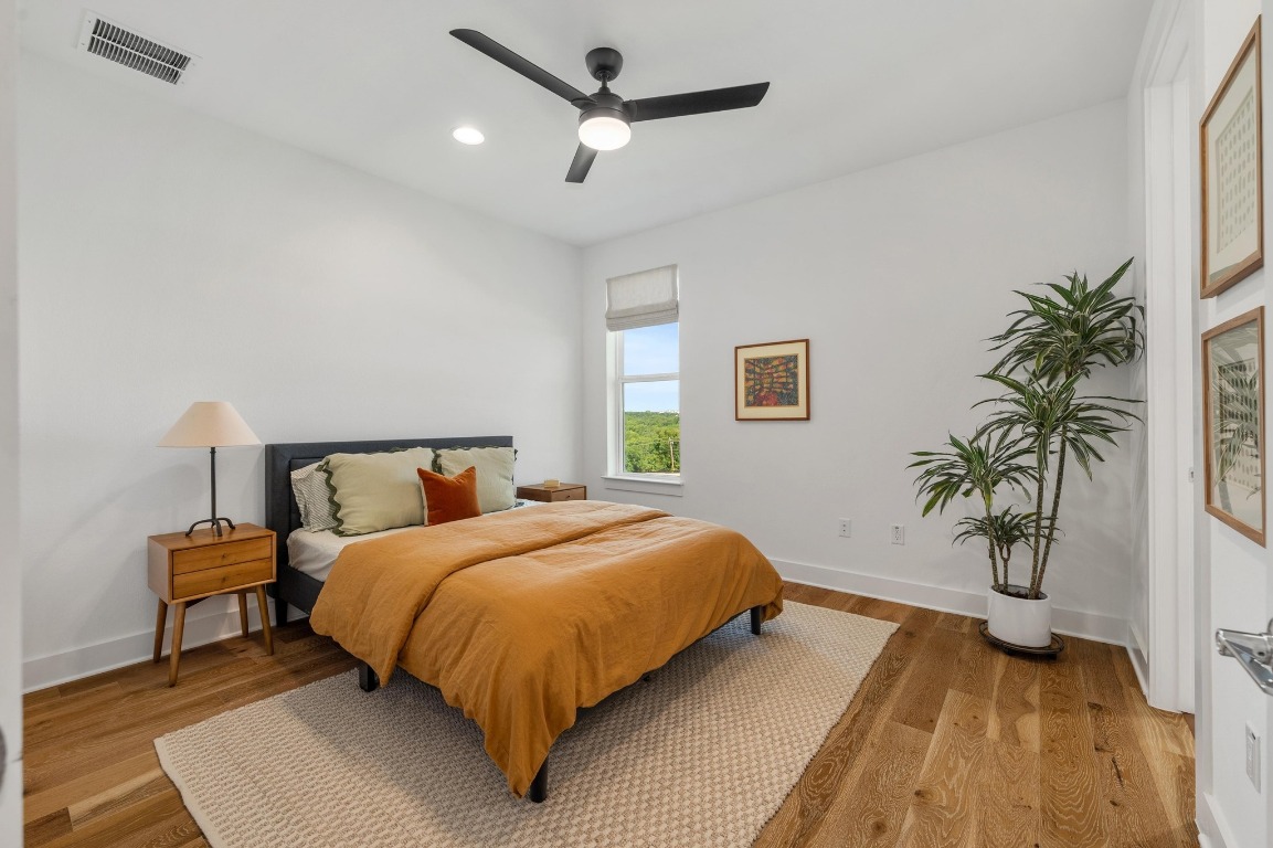 5428 Agatha Circle Austin, TX 78724 - Photo 21 of 40 a bedroom with bed and a potted plant