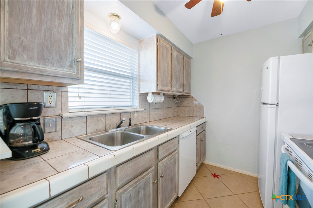 2003 North Fulton Beach Road, Unit 77 Rockport, TX 78382 - Photo 14 of 33 a kitchen with a sink and cabinets