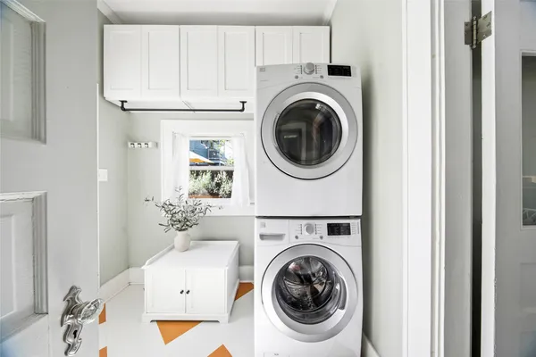 a view of a storage and utility room with washer and dryer