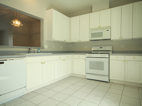 3384 Ravinia Circle Aurora, IL 60504 - Photo 3 of 24 a kitchen with white cabinets sink and white appliances