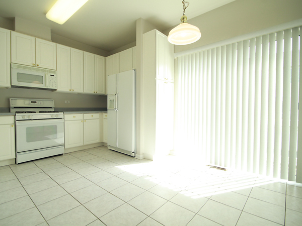 3384 Ravinia Circle Aurora, IL 60504 - Photo 4 of 24 a kitchen with stainless steel appliances granite countertop a stove a sink and a refrigerator
