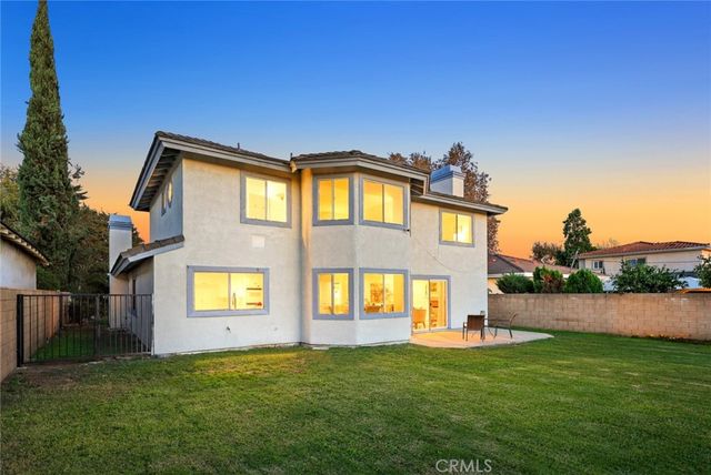 a view of a house with a backyard