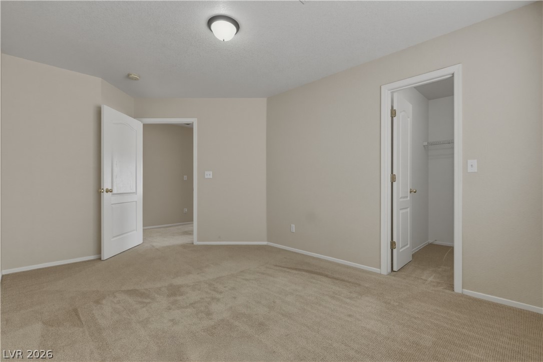 29 Olive Tree Henderson, NV 89074 - Photo 48 of 60 This inviting bedroom features soft carpeting and ample space, perfect for tranquil living.