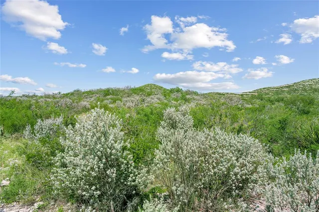 a view of a building in the middle of a field