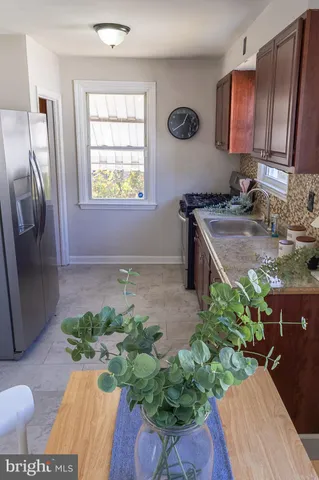 a view of a dining room with furniture and a potted plant