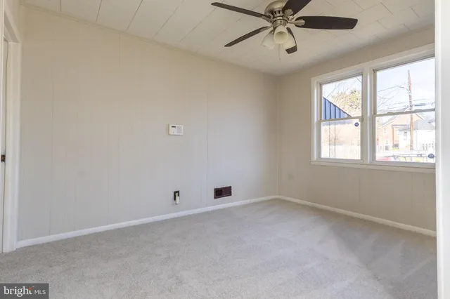 a bathroom with a sink a toilet and a window