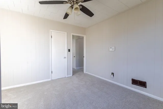 a bathroom with a granite countertop toilet sink and mirror