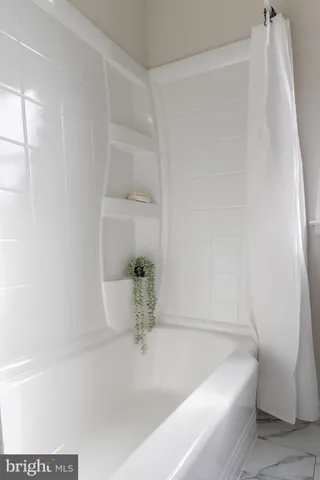 a kitchen with stainless steel appliances granite countertop a sink a stove a microwave a counter top space and cabinets