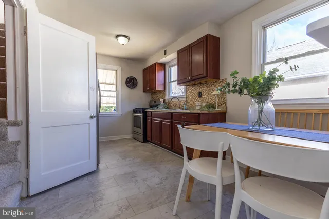 a kitchen with a sink a stove a refrigerator and a window