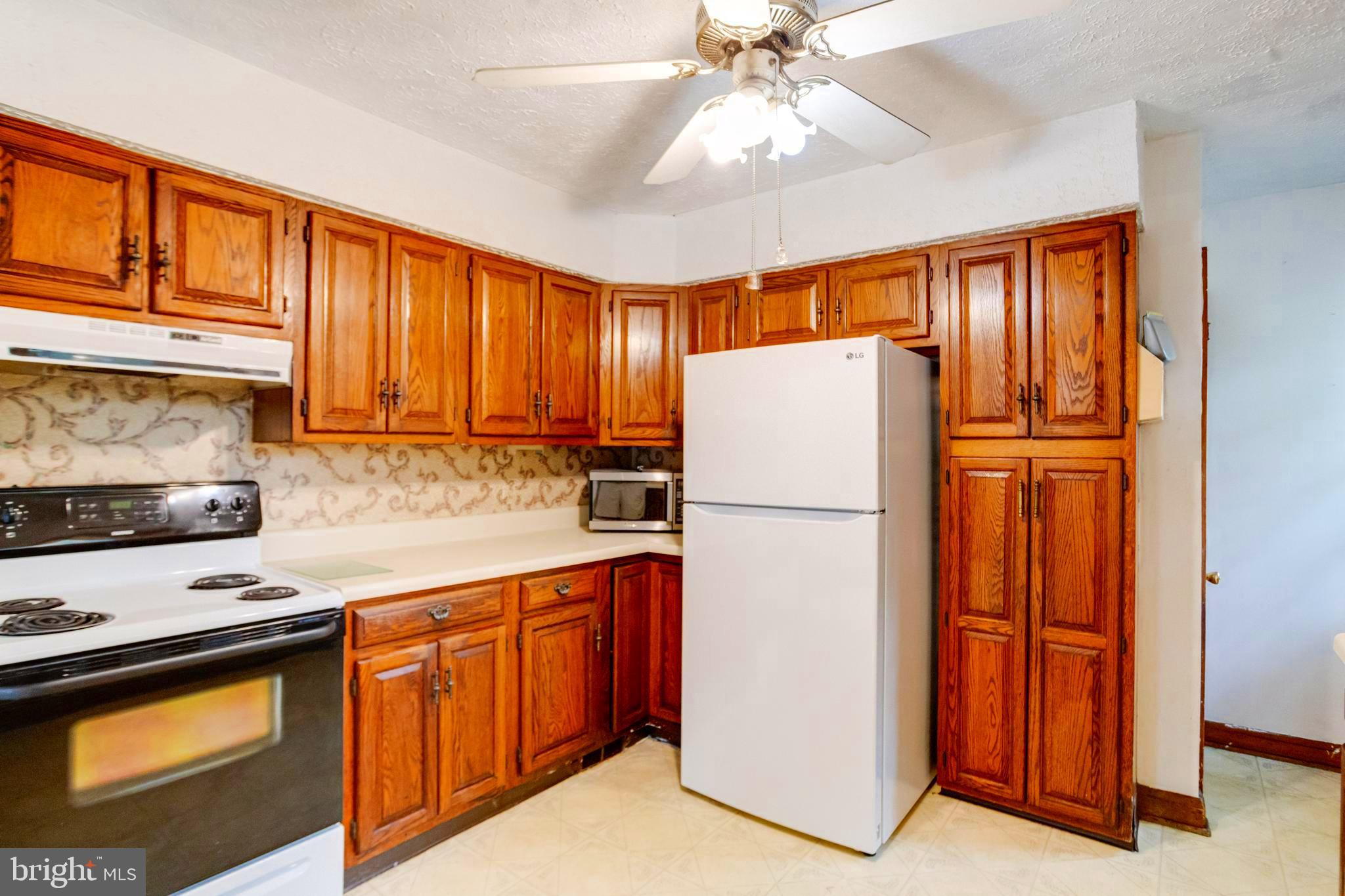 1405 Pomeroy Avenue Abingdon, MD 21009 - Photo 12 of 60 a white refrigerator freezer sitting in a kitchen with stainless steel appliances granite countertop cabinets and a refrigerator