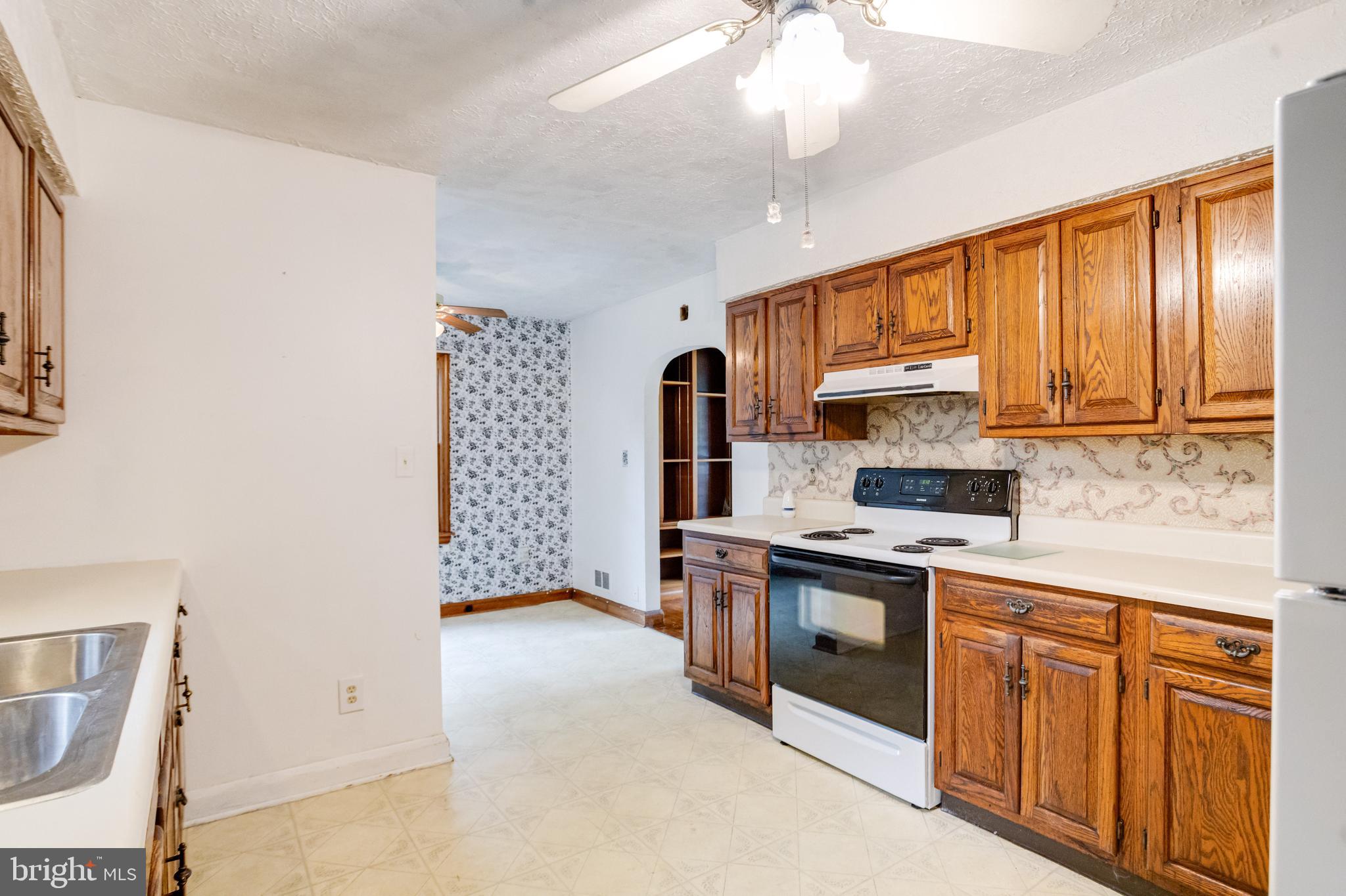 1405 Pomeroy Avenue Abingdon, MD 21009 - Photo 13 of 60 a kitchen with stainless steel appliances a sink a stove a refrigerator cabinets and a window
